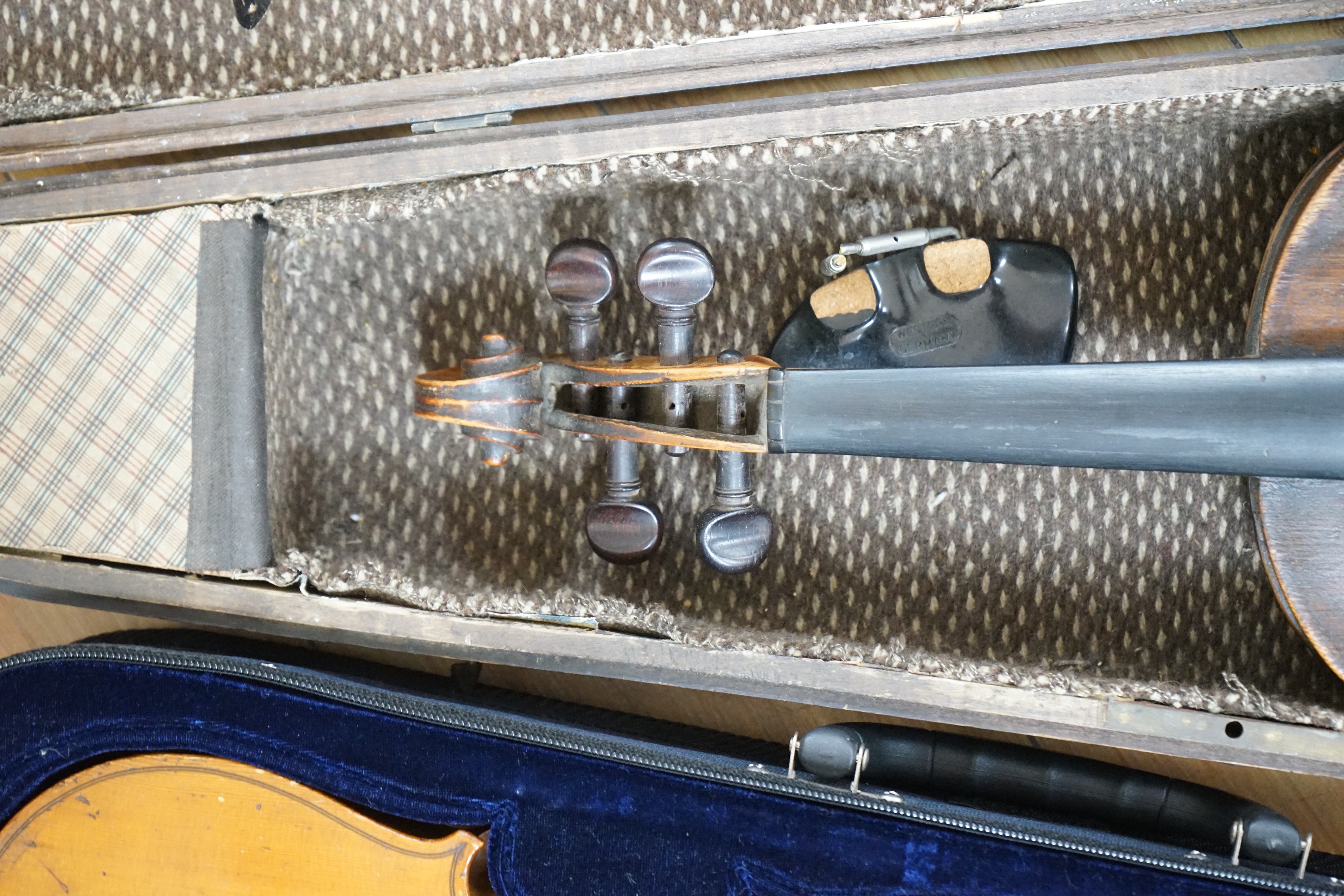 Two cased unnamed violins